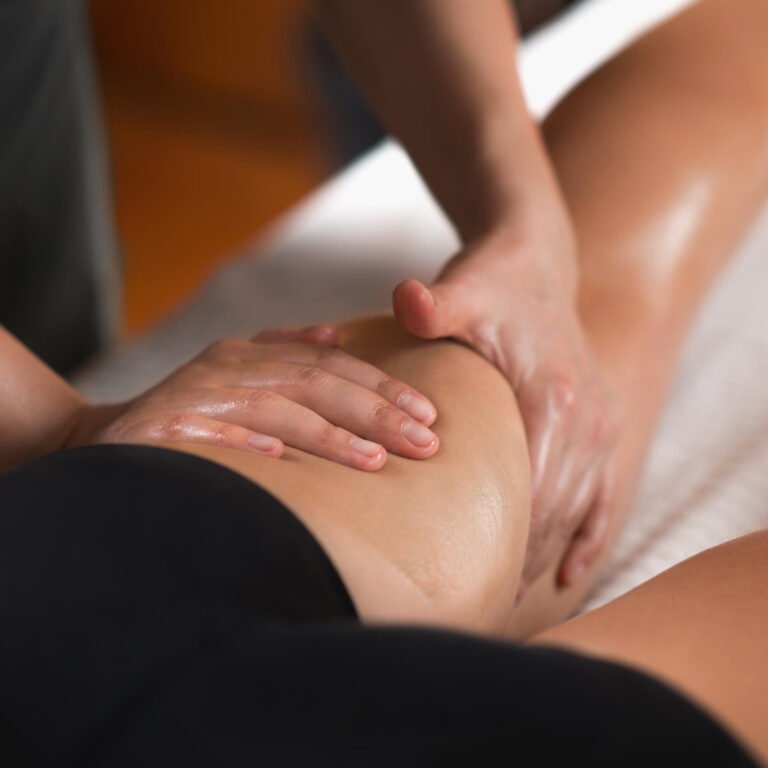Therapist massaging a client’s lower back